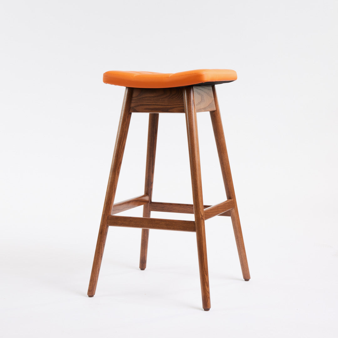 TH Brown Martelle Bar Stool in Calypso Orange with Dark Ash frame, blending vibrant colour and rich timber tones for bold modern Australian living.