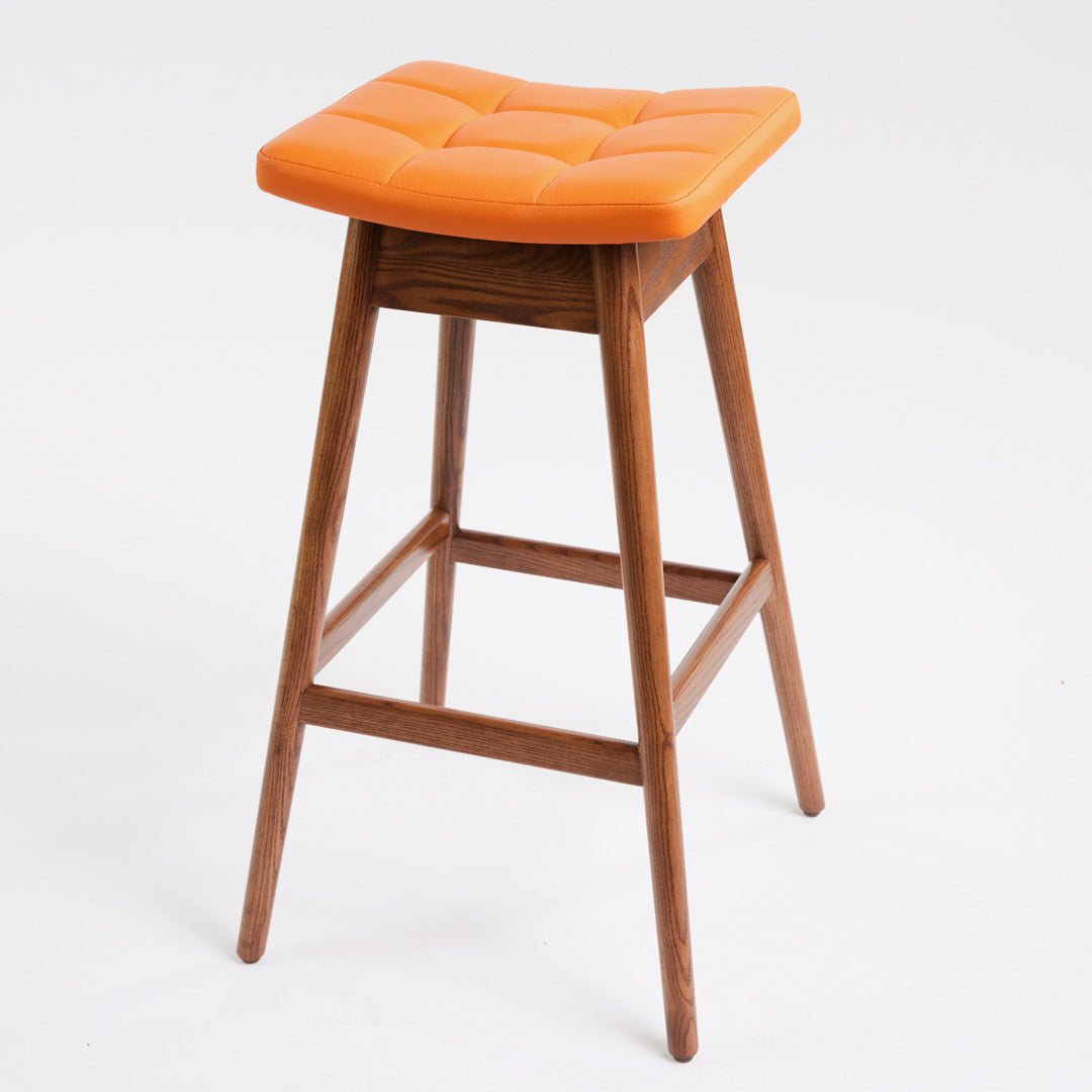 TH Brown Martelle Bar Stool in Calypso Orange with Dark Ash frame, blending vibrant colour and rich timber tones for bold modern Australian living.