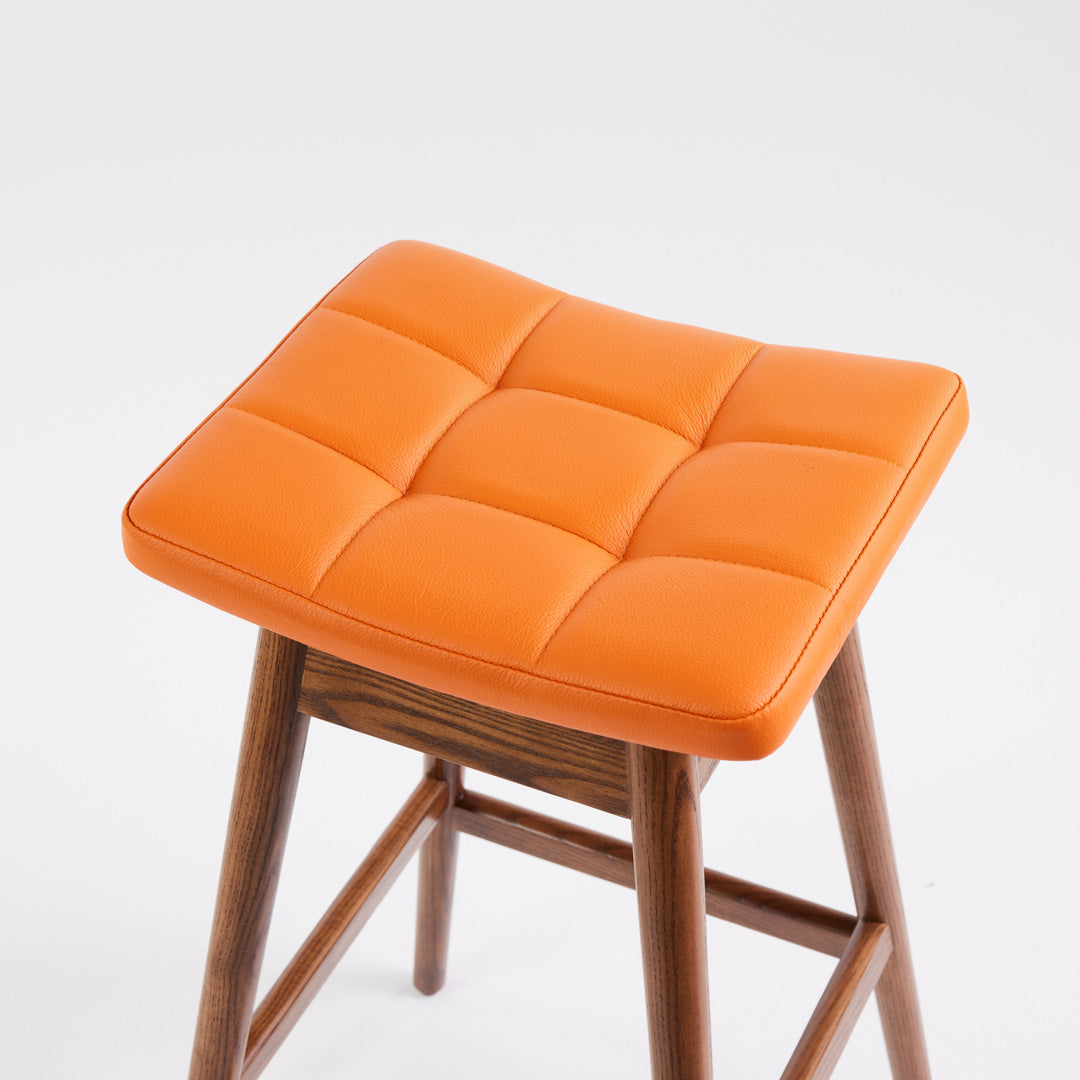 TH Brown Martelle Bar Stool in Calypso Orange with Dark Ash frame, blending vibrant colour and rich timber tones for bold modern Australian living.