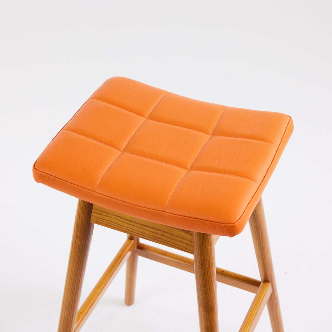 TH Brown Martelle Bar Stool in Calypso Orange with Light Ash frame, blending vibrant colour and pale timber for playful modern Australian living.