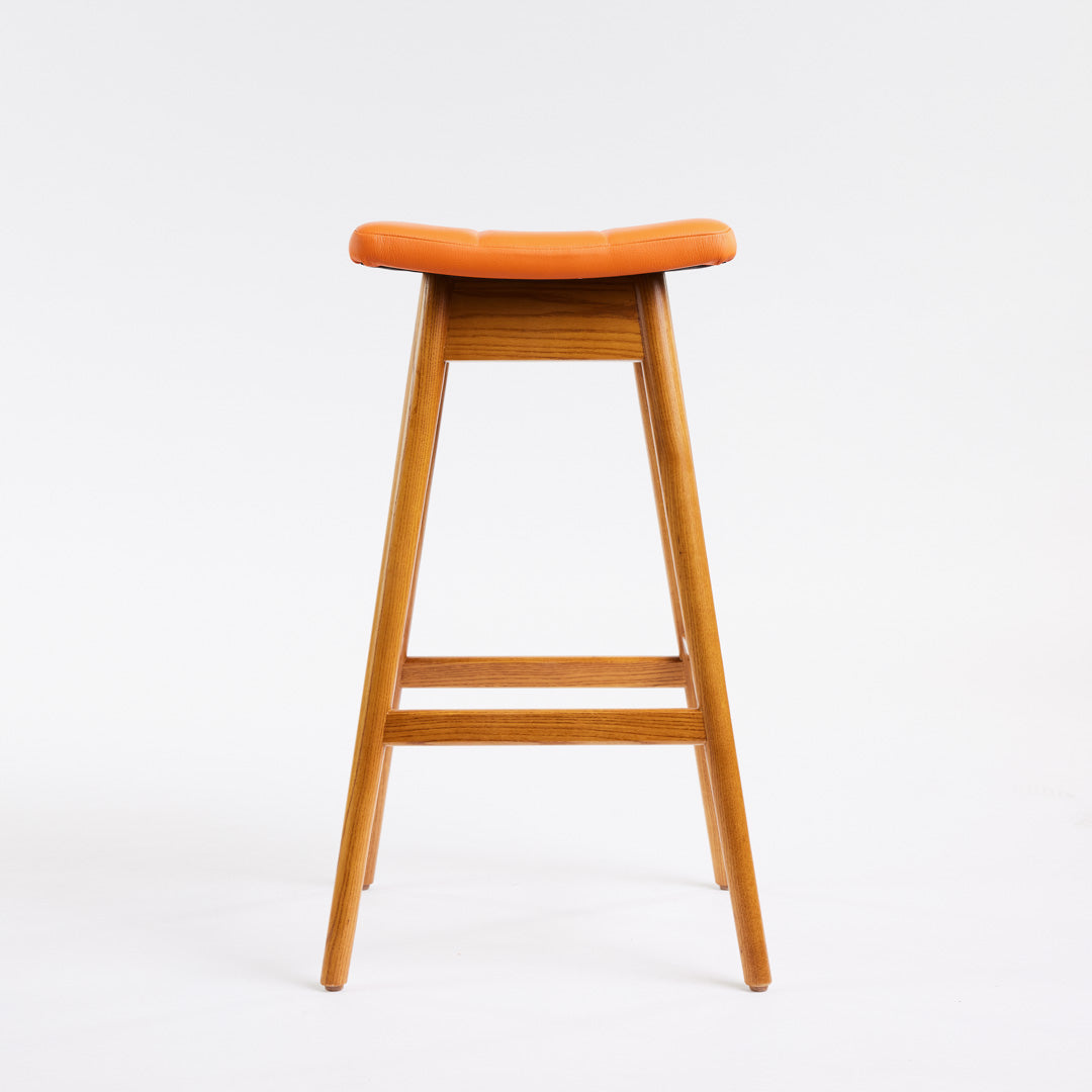 TH Brown Martelle Bar Stool in Calypso Orange with Light Ash frame, blending vibrant colour and pale timber for playful modern Australian living.