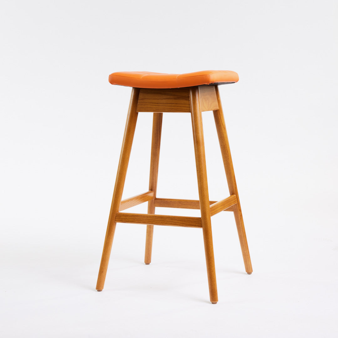 TH Brown Martelle Bar Stool in Calypso Orange with Light Ash frame, blending vibrant colour and pale timber for playful modern Australian living.