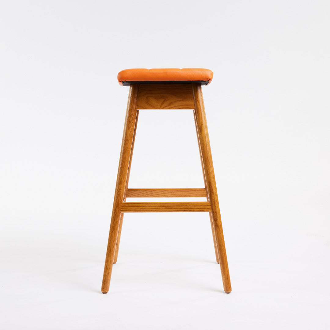 TH Brown Martelle Bar Stool in Calypso Orange with Light Ash frame, blending vibrant colour and pale timber for playful modern Australian living.