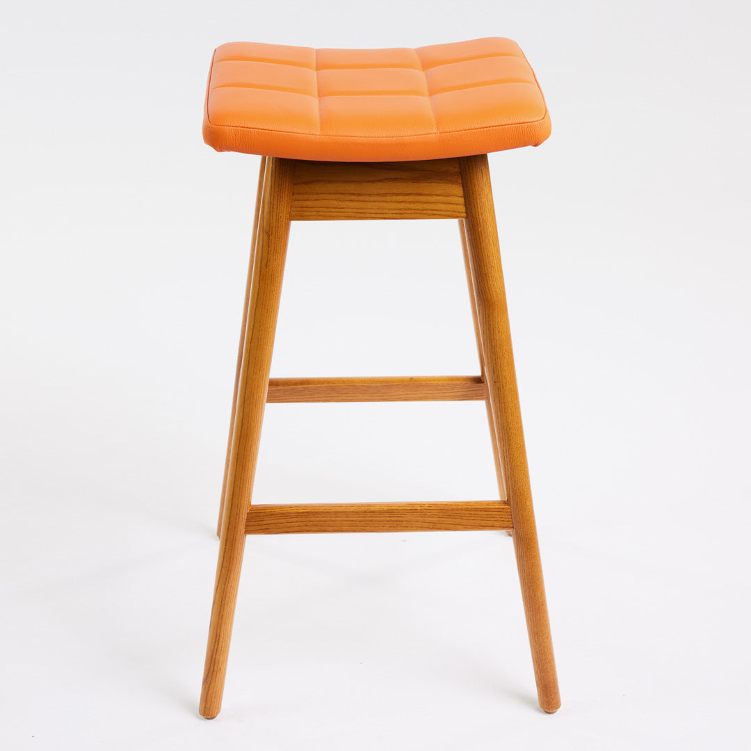TH Brown Martelle Bar Stool in Calypso Orange with Light Ash frame, blending vibrant colour and pale timber for playful modern Australian living.