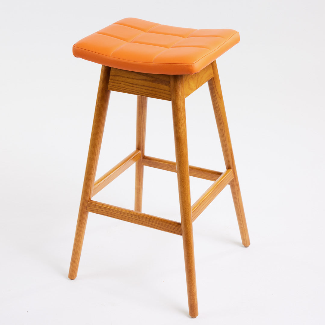 TH Brown Martelle Bar Stool in Calypso Orange with Light Ash frame, blending vibrant colour and pale timber for playful modern Australian living.