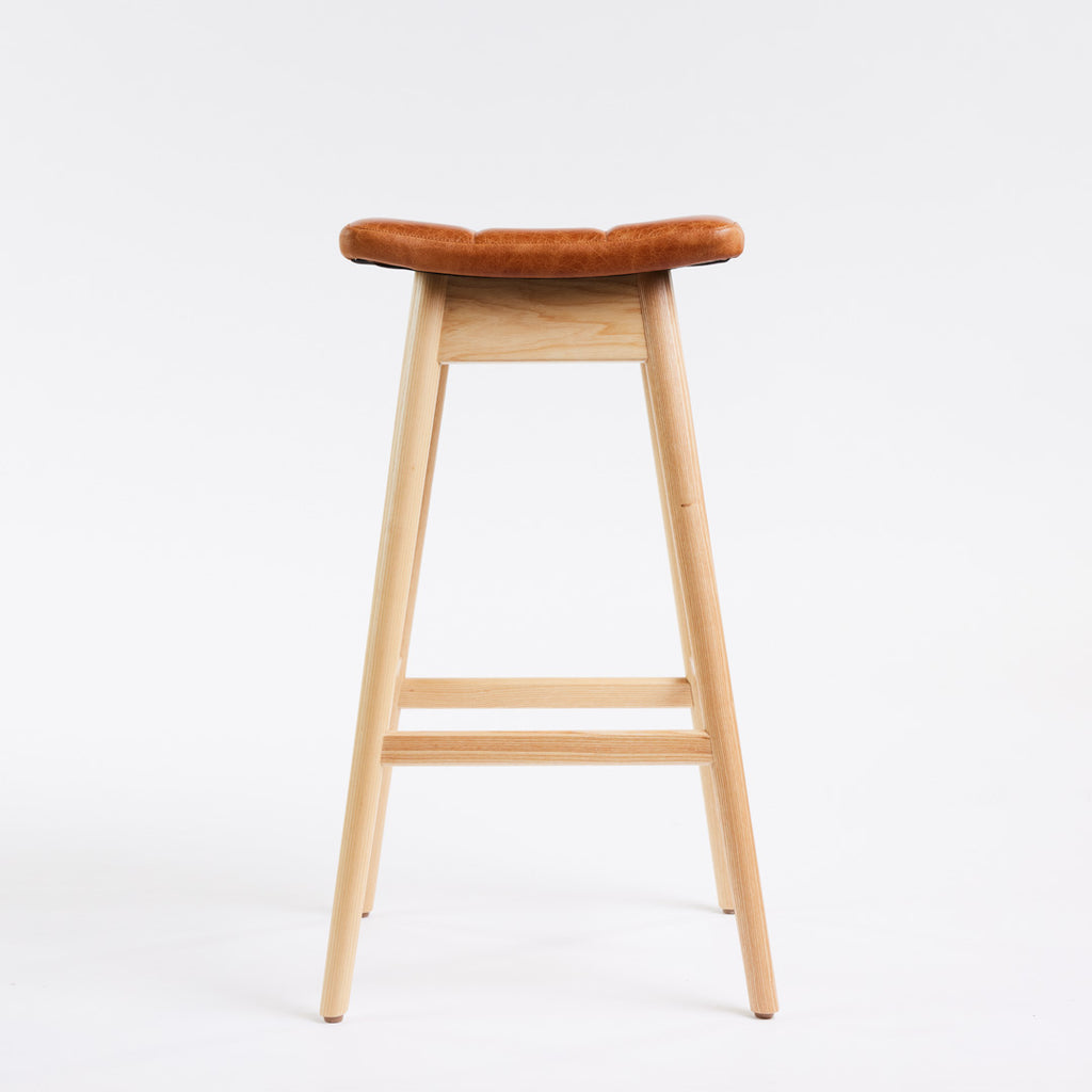 TH Brown Martelle Bar Stool in Oak Brown with Clear Ash frame, blending warm earthy upholstery and natural timber for relaxed modern Australian living.