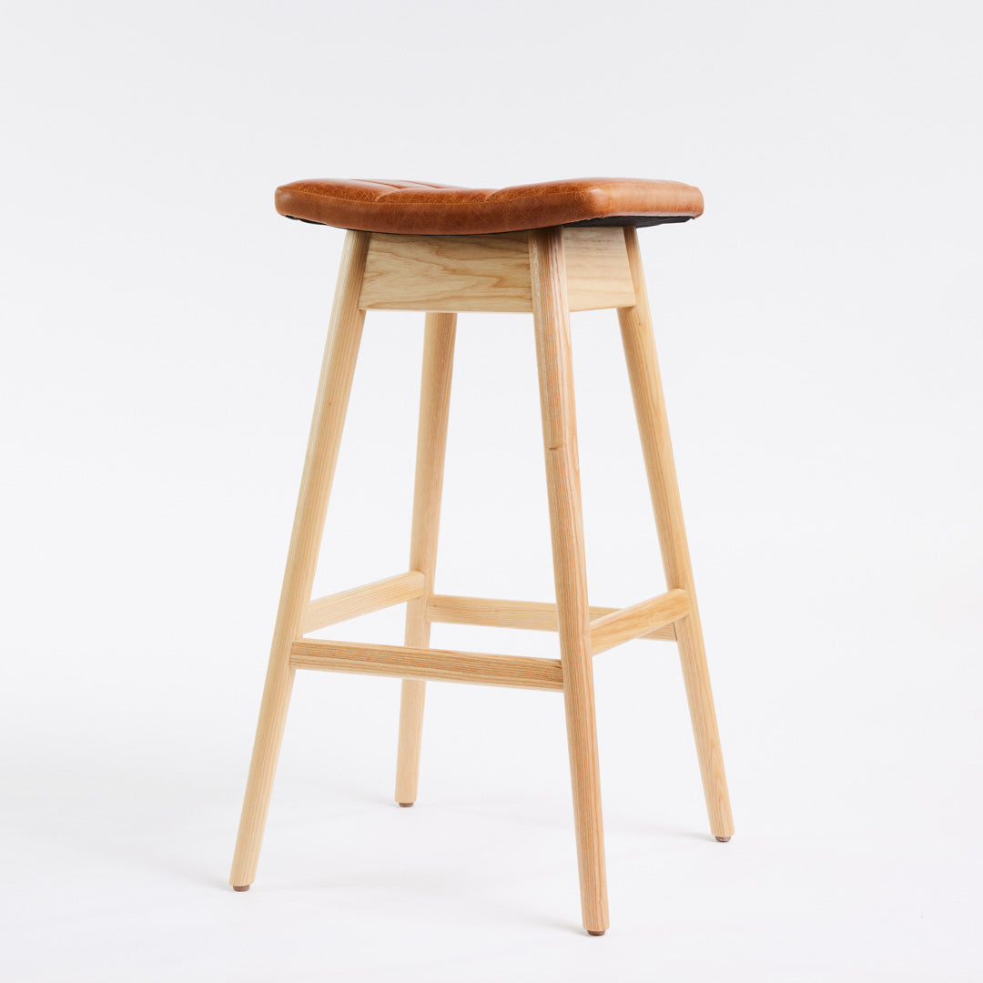 TH Brown Martelle Bar Stool in Oak Brown with Clear Ash frame, blending warm earthy upholstery and natural timber for relaxed modern Australian living.