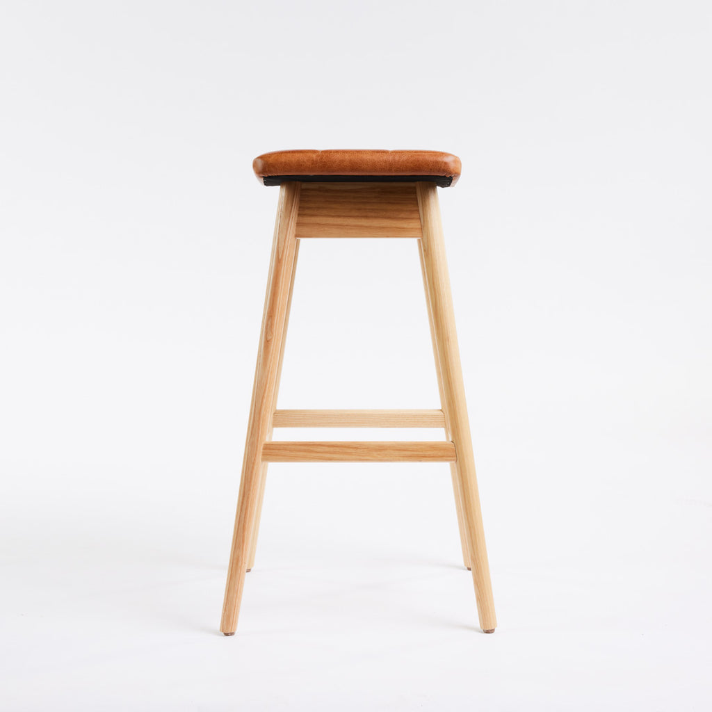 TH Brown Martelle Bar Stool in Oak Brown with Clear Ash frame, blending warm earthy upholstery and natural timber for relaxed modern Australian living.