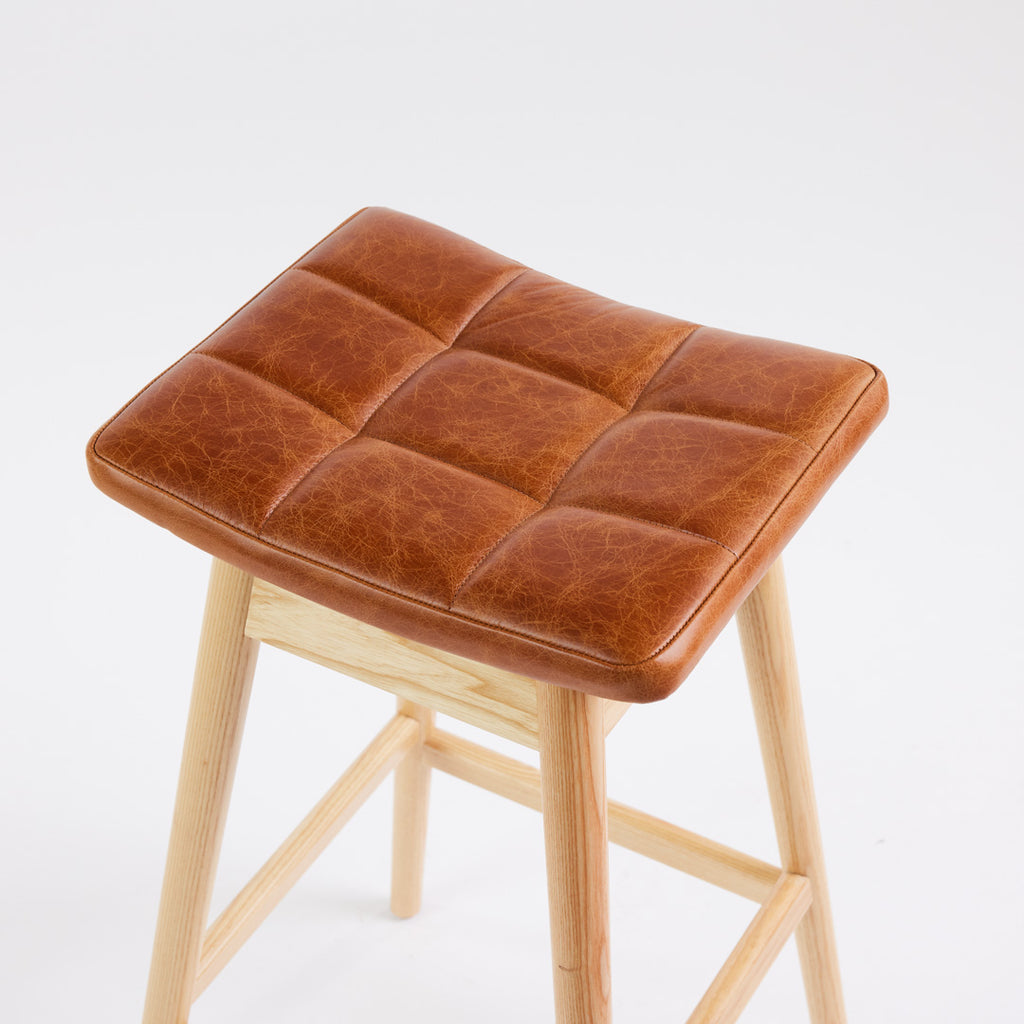 TH Brown Martelle Bar Stool in Oak Brown with Clear Ash frame, blending warm earthy upholstery and natural timber for relaxed modern Australian living.