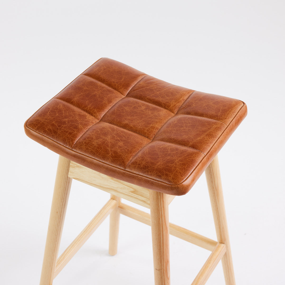 TH Brown Martelle Bar Stool in Oak Brown with Clear Ash frame, blending warm earthy upholstery and natural timber for relaxed modern Australian living.
