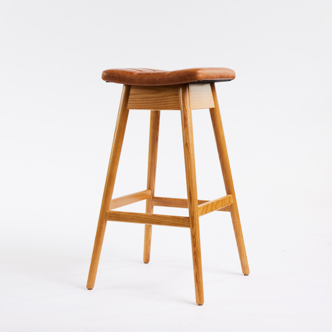 TH Brown Martelle Bar Stool in Oak Brown with Light Ash frame, blending warm earthy upholstery and pale timber for relaxed modern Australian living.
