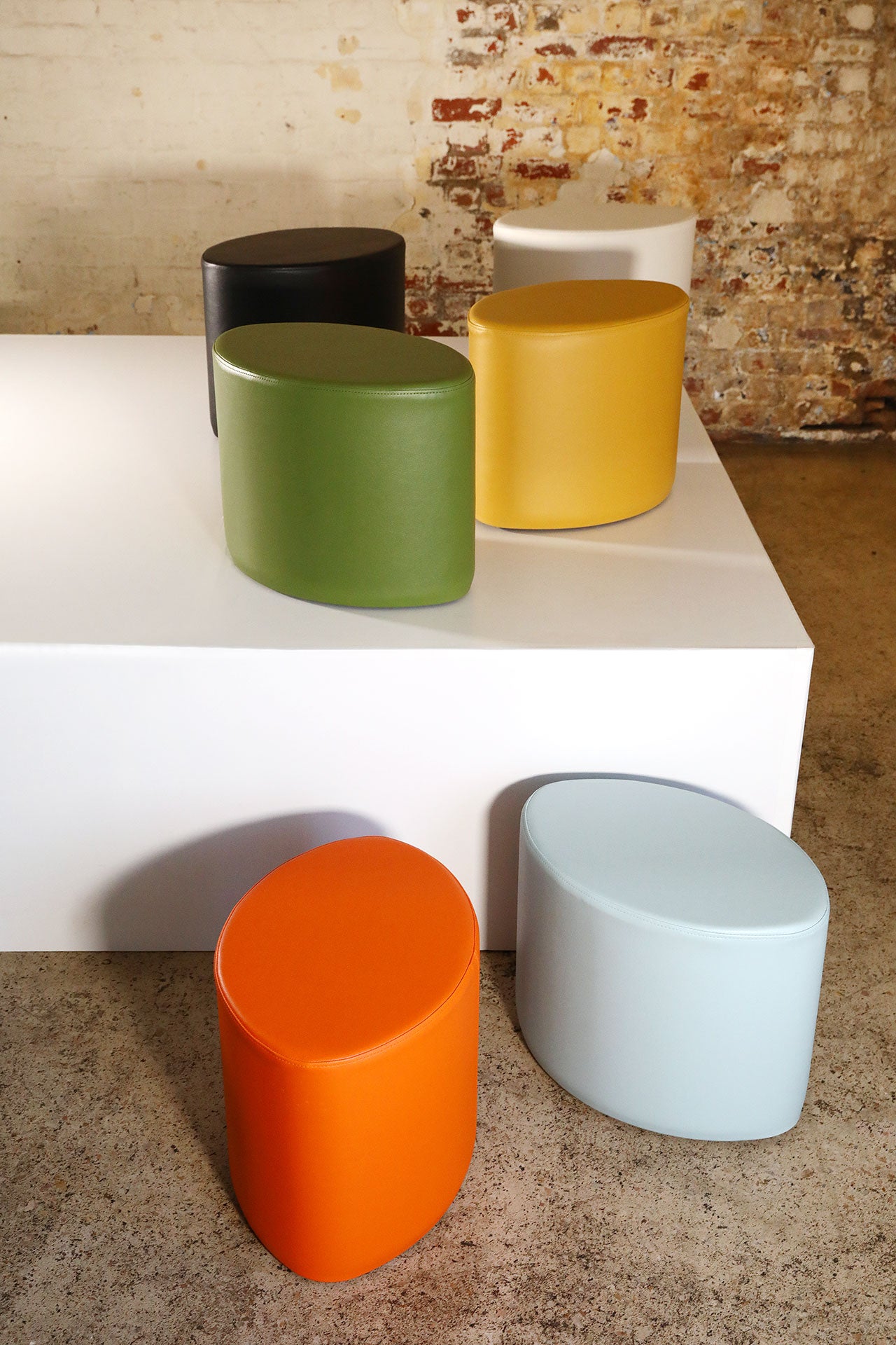 TH Brown Rondo Stools grouped over a platform, showcasing sculptural forms and playful mid-century style for modern Australian living.